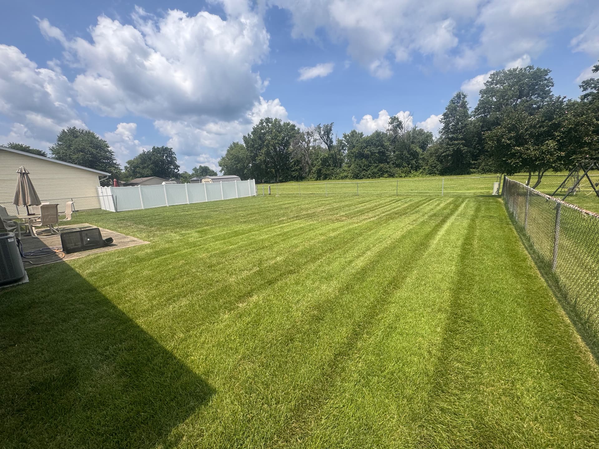 Large fenced backyard in Auburn IL with crisp mowing stripes