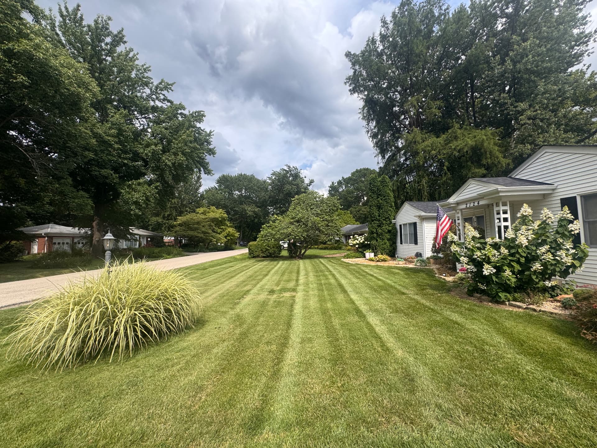Manicured front lawn with sharp stripes beside landscaping beds