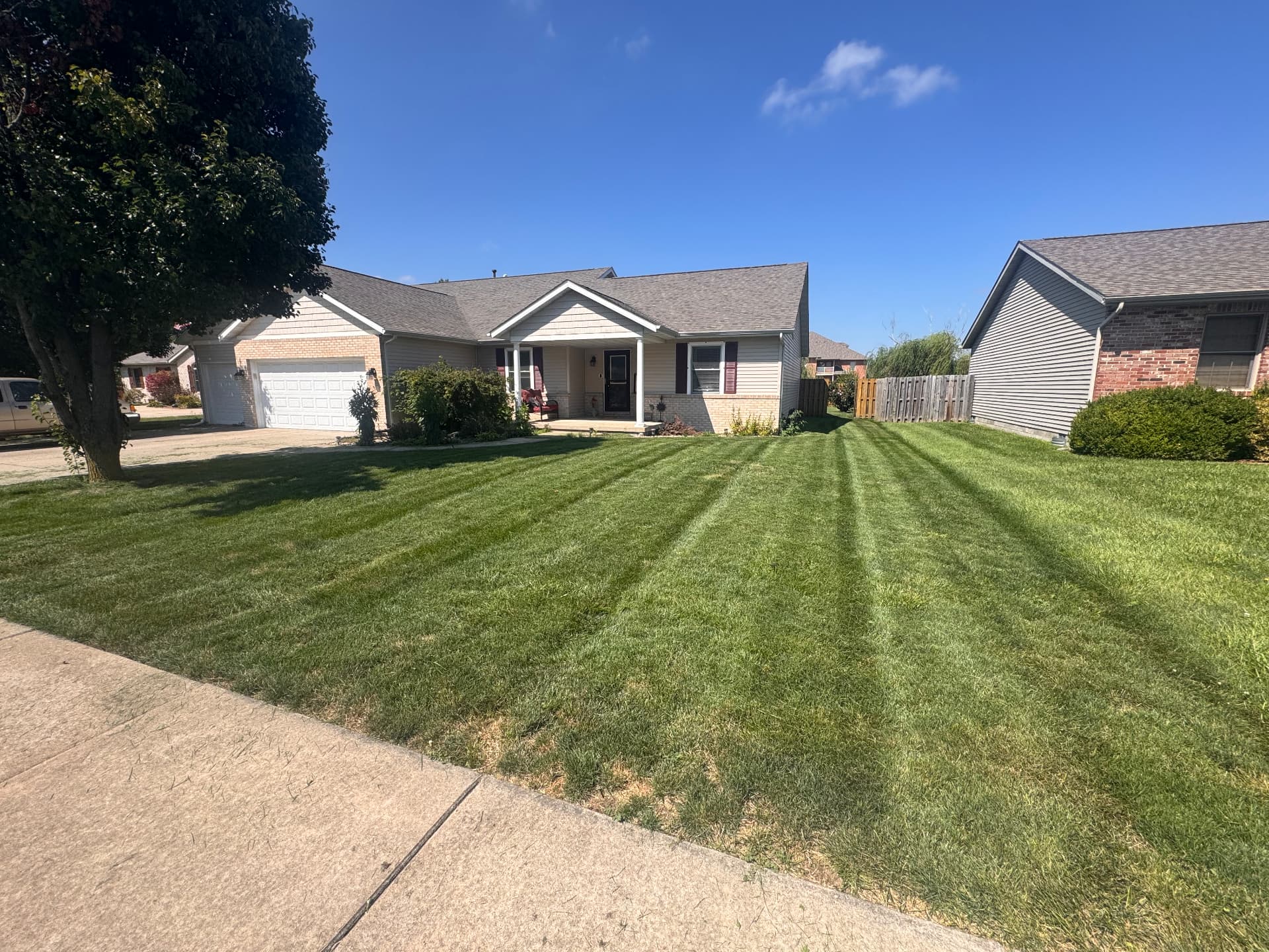 Front lawn striped clean from sidewalk to driveway
